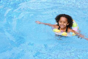A beautiful African American  child  swimming